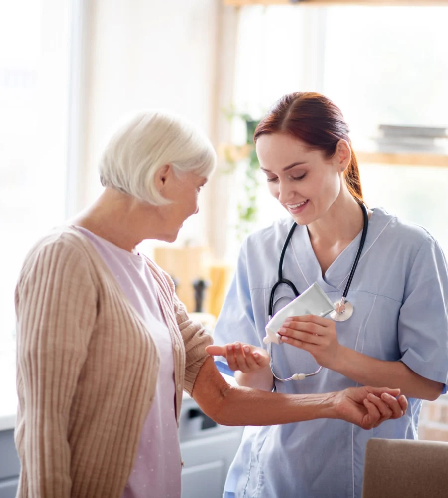 Caregiver using massage lotion while massaging arms